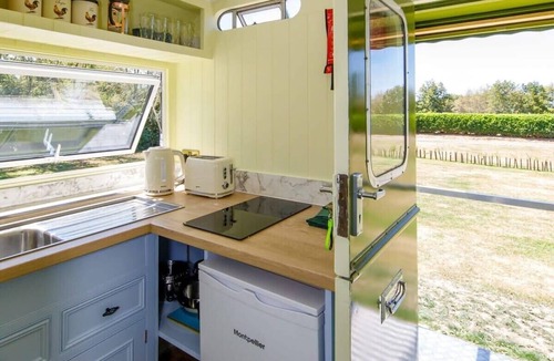 Birdham House | Restored Showman's Carriage with King Bed