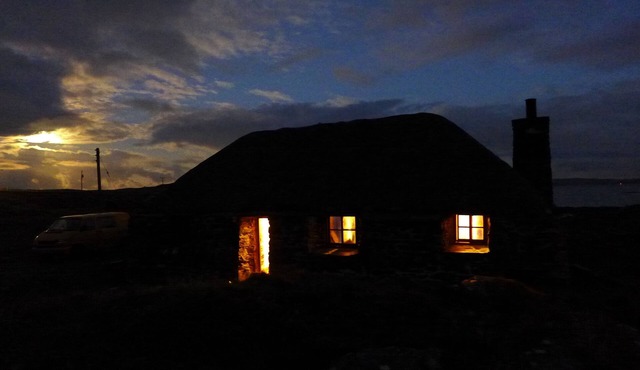 Traditional stone and thatch cottage on the waters edge with beautiful sea views