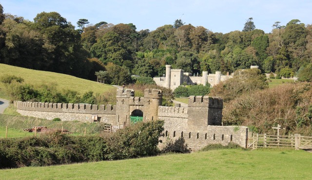Turreted gatehouse to the historic Caerhays Castle located on the beach on the south Cornish Coast